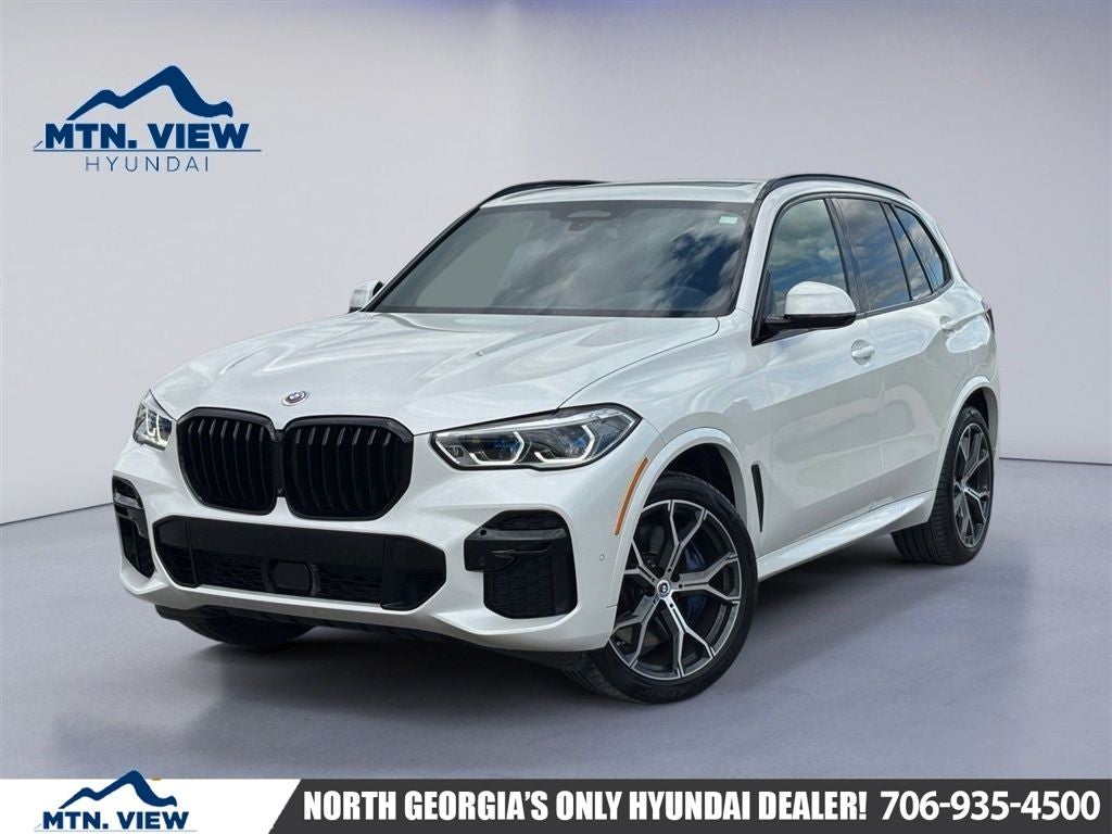 2023 BMW X5 M50i in Mineral White Metallic — front three-quarter view